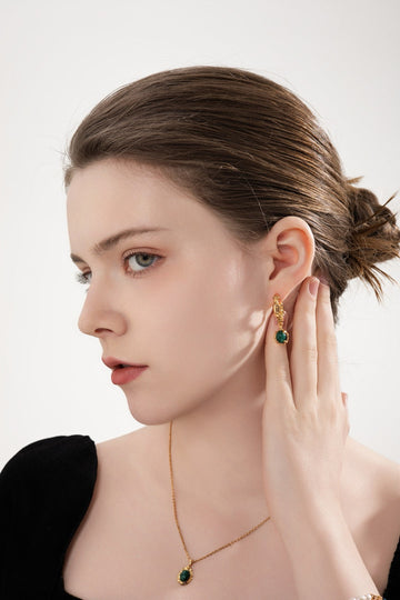 Emerald Earrings with timeless and elegant design worn by a model.