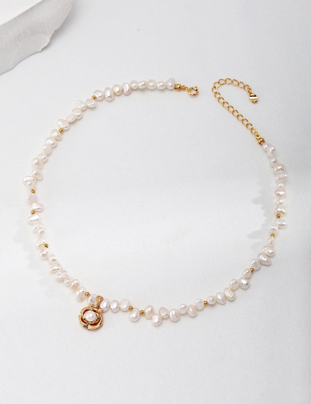 Camellia Pearl Necklace with gold chain and camellia pendant.