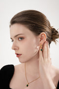 Emerald Earrings with timeless and elegant design worn by a model.