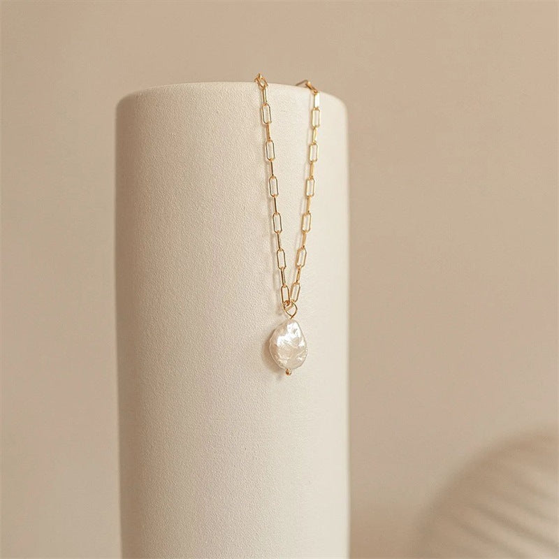 Small-link chain pearl pendant necklace with stainless steel and 14K gold plating.
